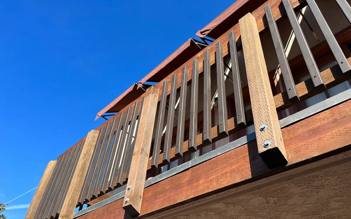 AWC elevated railing with wood posts, visible bolts and metal balusters